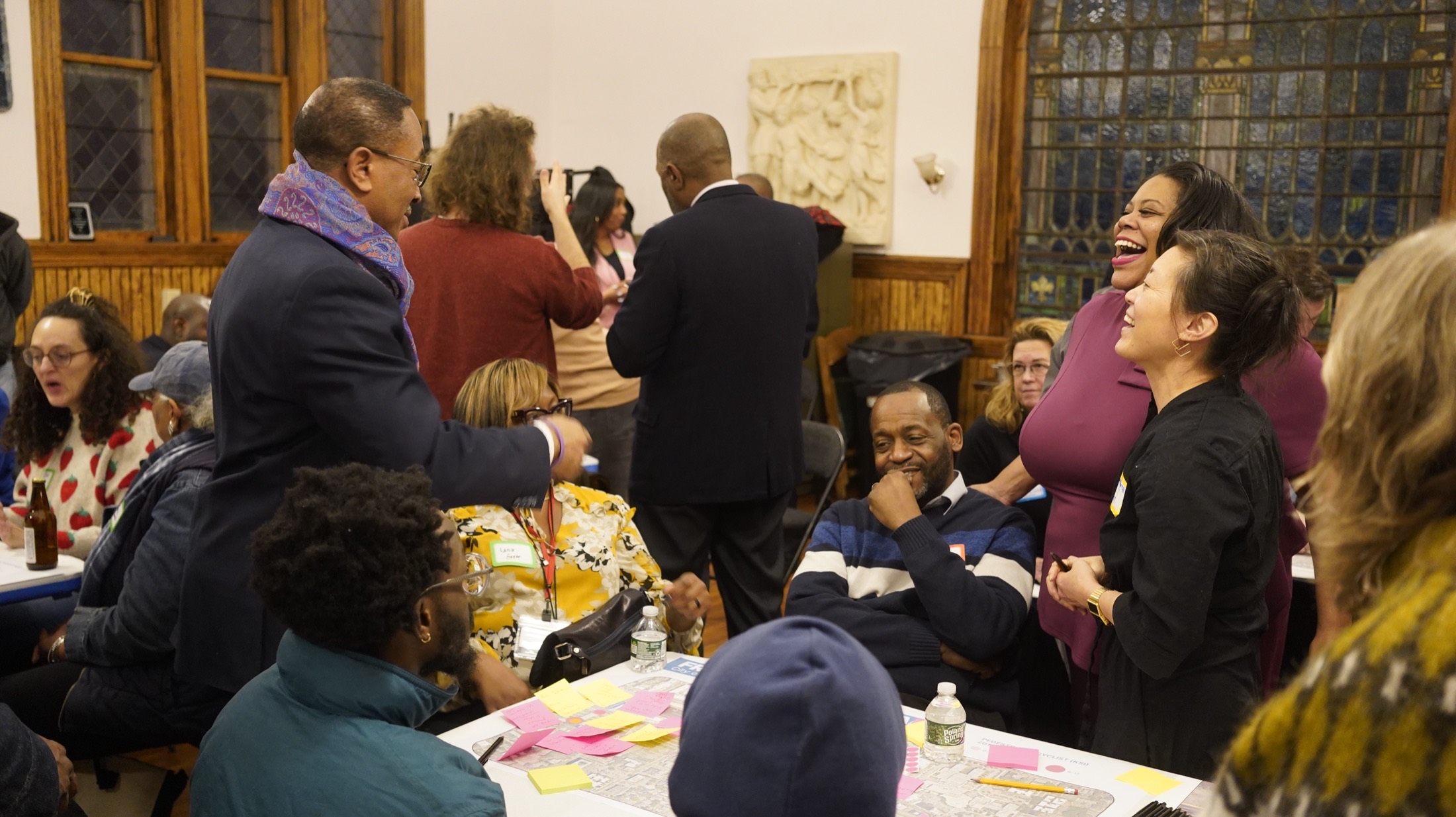 Attendees sharing a laugh at the community mapping meeting