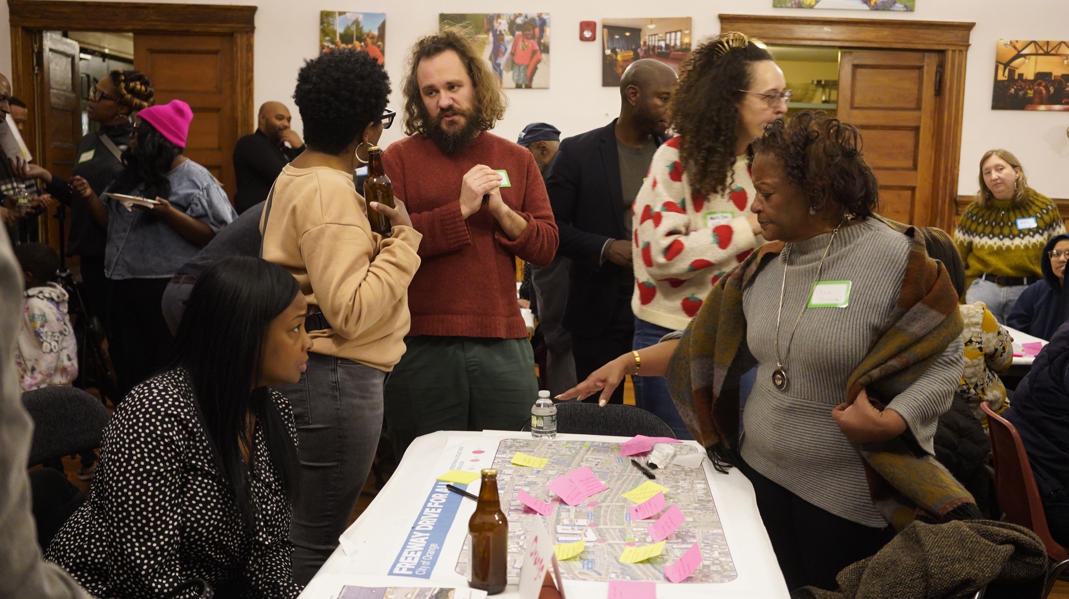 Residents gathered around a table marking up a corridor map with sticky notes