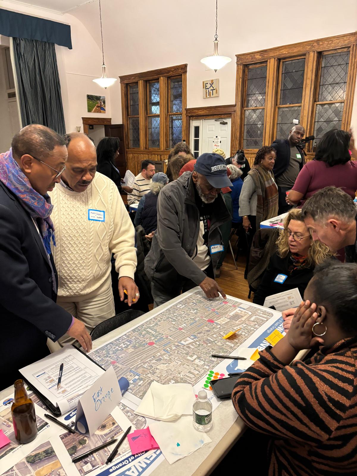 Residents and officials reviewing a corridor map at a community meeting