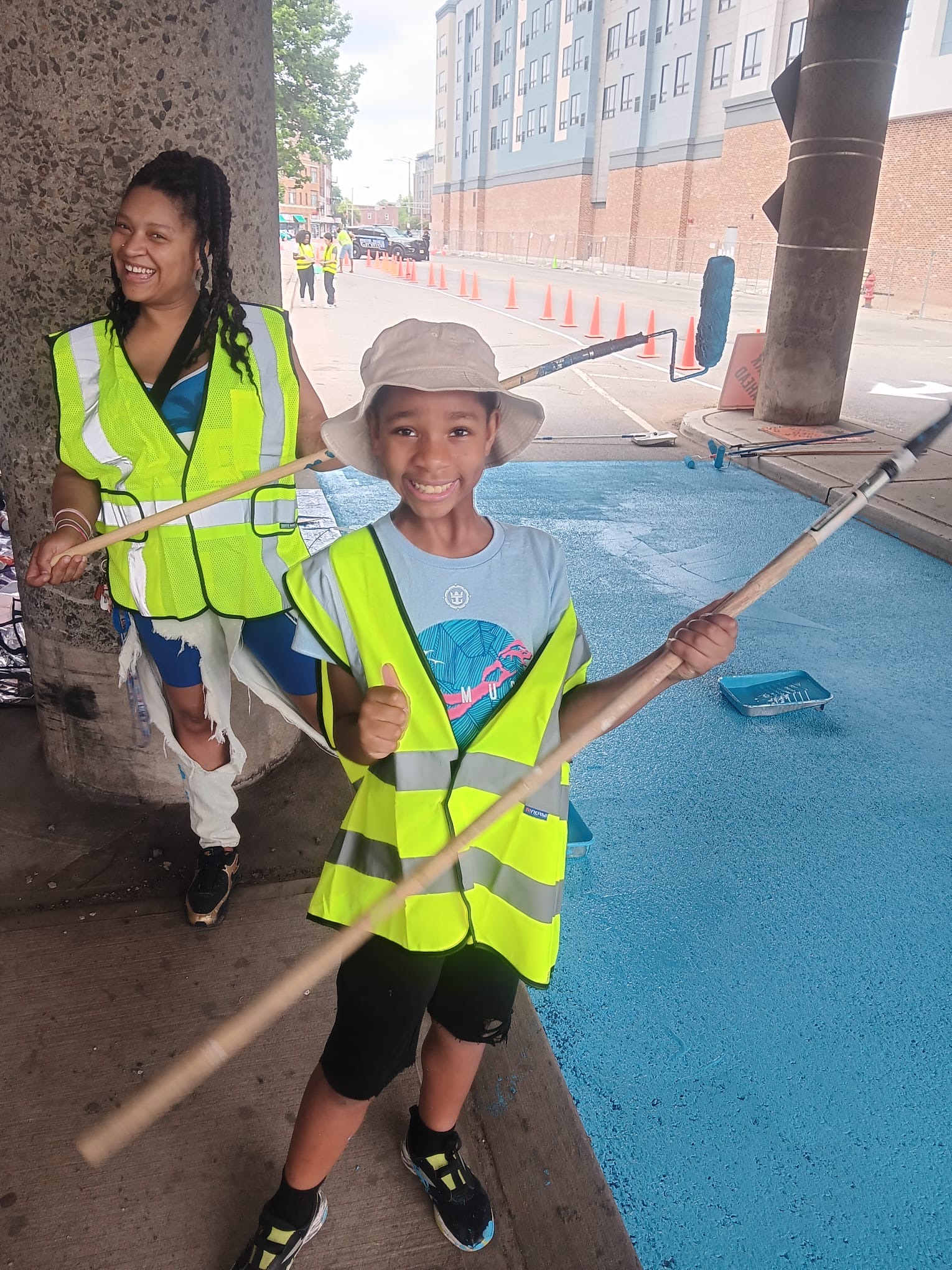 East Orange volunteer painters, including a young resident