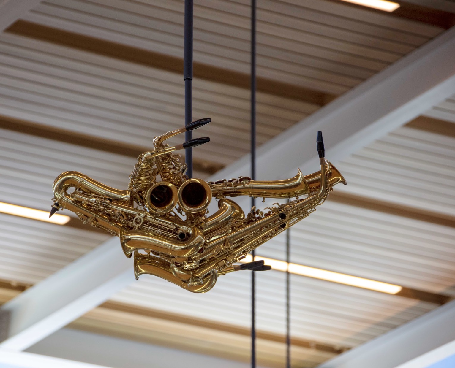 Saxophone-bird sculpture suspended from the terminal ceiling