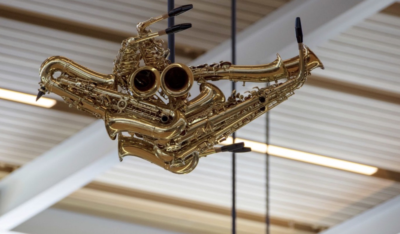 Close-up detail of a saxophone-bird sculpture